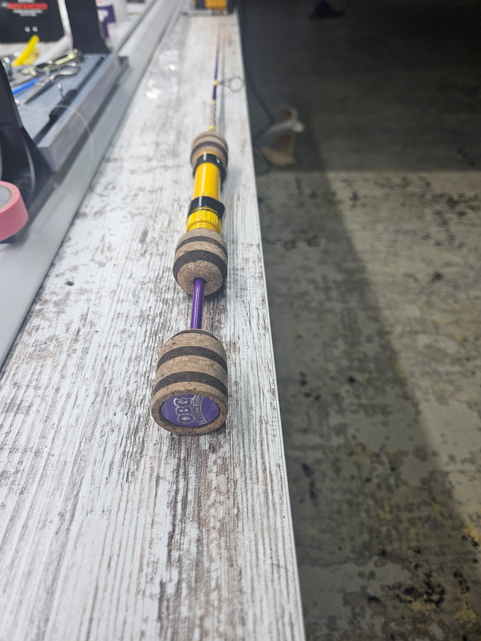 Sold 36-inch V-Line Gnarly Noodle custom rod with Mud Hole Color Series reel seat, American Tackle SSR guides, cork grip, and purple and yellow color scheme