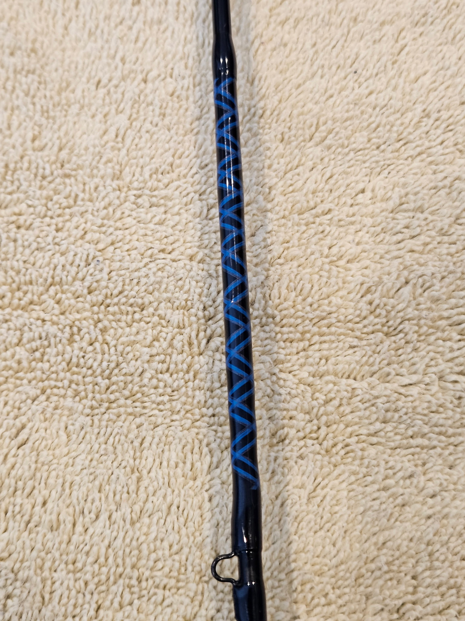 Ice fishing rod build in progress — guide wrap being applied to a graphite blank
