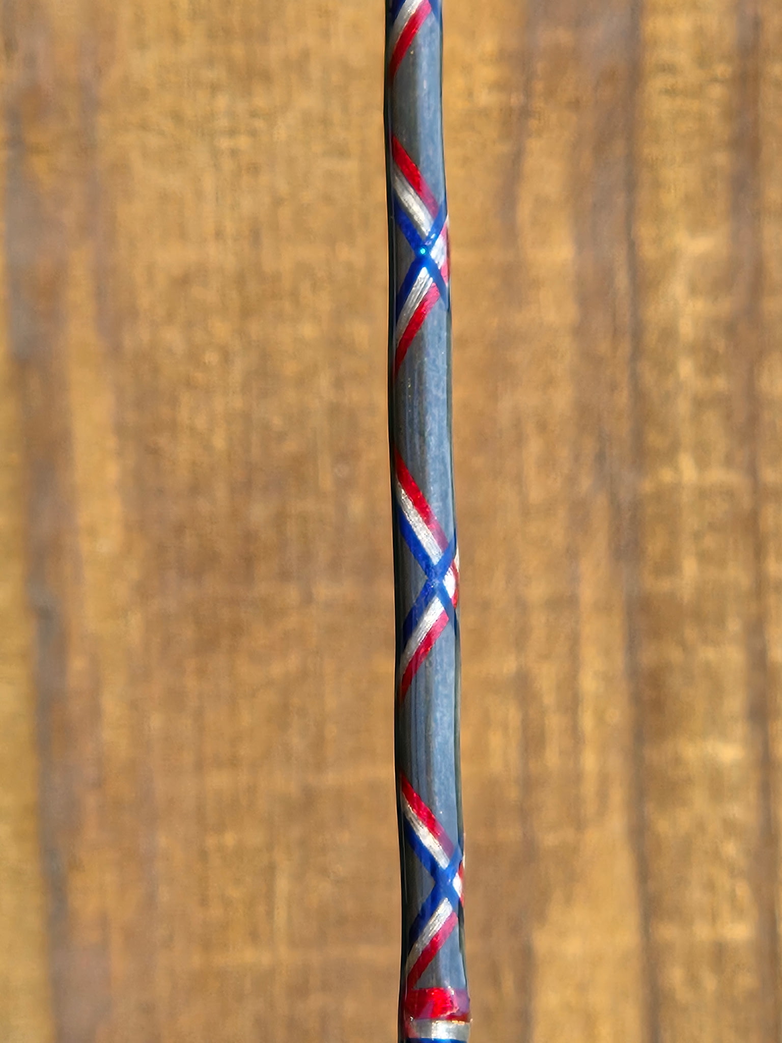 Finished OBG custom rod showing tip guides and thread wrap detail under bright light