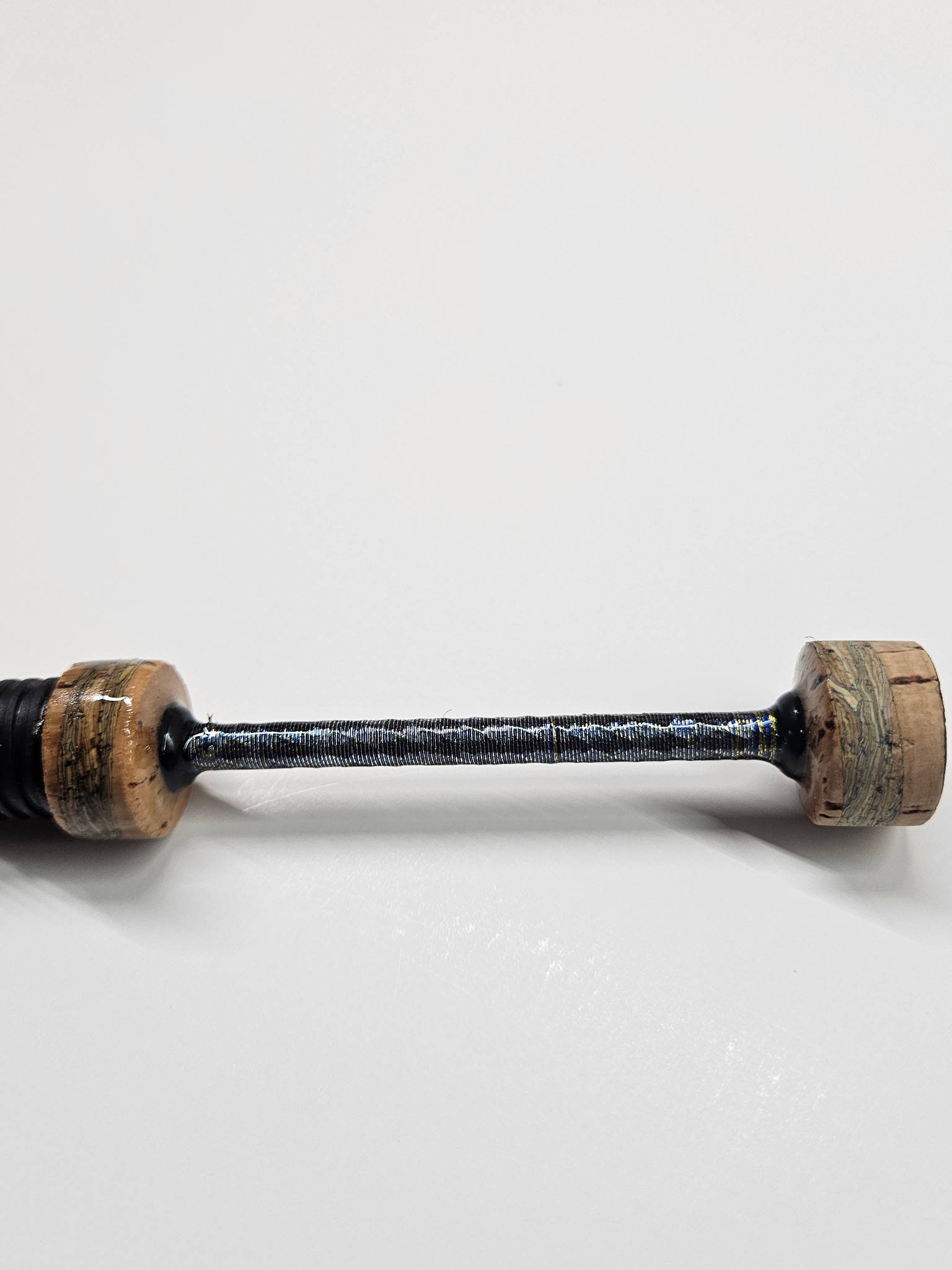 Close-up of multi-color thread wraps on a completed OBG custom fishing rod